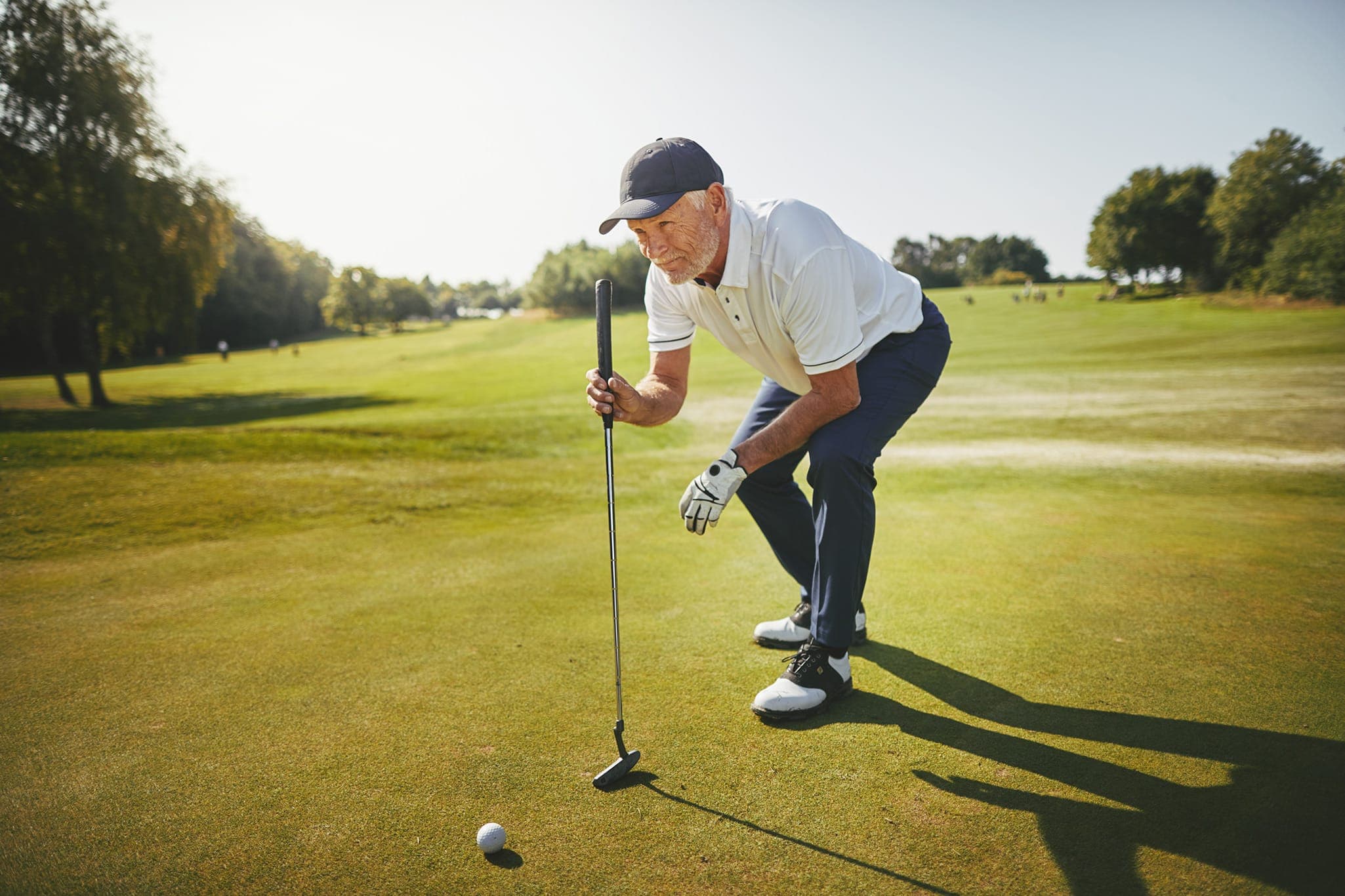 Active adult playing golf
